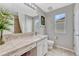 Bright bathroom featuring a large mirror, vanity with sink, and tile flooring at 5625 S Buchanan St, Aurora, CO 80016