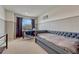 Comfortable bedroom with a daybed, desk, and window providing natural light, creating a versatile space at 5625 S Buchanan St, Aurora, CO 80016