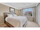 Comfortable bedroom with a queen-size bed, and a large window offering natural light at 5625 S Buchanan St, Aurora, CO 80016