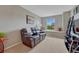 Cozy bonus room with plush seating, a bright window nook, and entertainment setup for relaxation at 5625 S Buchanan St, Aurora, CO 80016