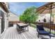 Outdoor deck area features patio furniture and an umbrella for shade at 5625 S Buchanan St, Aurora, CO 80016