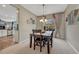 Cozy dining room with a wooden table set for four, a window with curtains, and elegant lighting at 5625 S Buchanan St, Aurora, CO 80016
