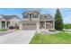 Beautiful two-story home with a well-maintained lawn, stone details, and a convenient two-car garage at 5625 S Buchanan St, Aurora, CO 80016
