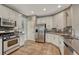 Spacious kitchen with white cabinets, stainless steel appliances, and tile flooring at 5625 S Buchanan St, Aurora, CO 80016
