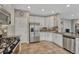 Functional kitchen with white cabinets, stainless steel appliances, and ample countertop space at 5625 S Buchanan St, Aurora, CO 80016