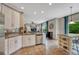 Open kitchen with white cabinetry, stainless steel appliances, tile backsplash, and a view into the living area at 5625 S Buchanan St, Aurora, CO 80016