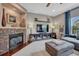 Comfortable living room featuring a fireplace, television, and plush seating, perfect for relaxation at 5625 S Buchanan St, Aurora, CO 80016