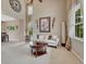 Bright living room with high ceilings, large windows, neutral color scheme, and stylish decor at 5625 S Buchanan St, Aurora, CO 80016