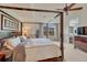 Spacious main bedroom featuring a canopy bed, ceiling fan, large windows, and en-suite bath at 5625 S Buchanan St, Aurora, CO 80016