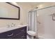 Updated bathroom with a walk-in shower, sleek vanity, and modern finishes at 8562 E 49Th Pl, Denver, CO 80238