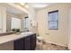 Well-lit bathroom featuring a vanity, neutral tiling, and a shower with curtain at 8562 E 49Th Pl, Denver, CO 80238