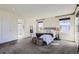 Primary bedroom showcasing carpet flooring, three windows, and a modern decorative ladder at 8562 E 49Th Pl, Denver, CO 80238