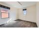 Empty bedroom features neutral walls, carpet flooring, and two windows at 8562 E 49Th Pl, Denver, CO 80238