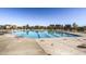 Inviting community pool with lounge chairs and neighborhood homes in the distance at 8562 E 49Th Pl, Denver, CO 80238