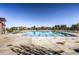 Beautiful community pool surrounded by lounge chairs and well-manicured landscaping at 8562 E 49Th Pl, Denver, CO 80238