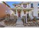 Inviting front entrance with a red door, white trim, and a well-maintained walkway at 8562 E 49Th Pl, Denver, CO 80238