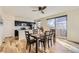 Well-lit kitchen and dining area with modern appliances, stylish table set and hardwood floors at 8562 E 49Th Pl, Denver, CO 80238