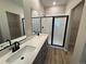 Elegant bathroom with double vanity and large shower at 9463 Yampa Ct, Commerce City, CO 80022