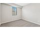 Comfortable carpeted bedroom with a window, neutral walls, and ample light at 9463 Yampa Ct, Commerce City, CO 80022