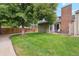Spacious backyard features lush green grass and mature trees, providing a serene outdoor retreat at 14333 E Warren Pl, Aurora, CO 80014
