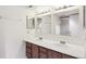 Bathroom features a double sink vanity, mirrors, and a walk-in shower at 14333 E Warren Pl, Aurora, CO 80014