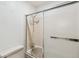 Bathroom with a bathtub and shower featuring glass sliding doors, designed for convenience and comfort at 14333 E Warren Pl, Aurora, CO 80014