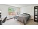Bedroom with a large window, offering ample natural light, and featuring simple decor, providing a calm and relaxing atmosphere at 14333 E Warren Pl, Aurora, CO 80014