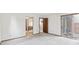 Bedroom with mirrored closet doors and a sliding glass door, providing ample space and natural light. Features access to an exterior patio at 14333 E Warren Pl, Aurora, CO 80014