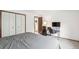 Bright bedroom featuring a work space, neutral walls, and a closet for storage at 14333 E Warren Pl, Aurora, CO 80014