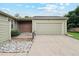 Charming exterior featuring a 2-car garage, lovely green paint, and a rock feature in the front yard at 14333 E Warren Pl, Aurora, CO 80014