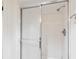 Walk-in shower featuring tiled walls and a glass sliding door at 14333 E Warren Pl, Aurora, CO 80014