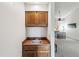 Wet bar featuring wooden cabinets, a stainless steel sink, and access to a dining area, ideal for entertaining guests at 14333 E Warren Pl, Aurora, CO 80014