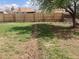 Large backyard with a wooden fence and grassy areas, perfect for outdoor activities and relaxation at 1326 S Canosa Ct, Denver, CO 80219