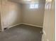 Finished basement with new carpet and a window at 1326 S Canosa Ct, Denver, CO 80219