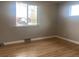 Bright bedroom showcasing gleaming hardwood floors and natural light from the windows at 1326 S Canosa Ct, Denver, CO 80219