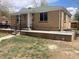 Charming brick home with a covered front porch and well-maintained landscaping, enhancing its curb appeal at 1326 S Canosa Ct, Denver, CO 80219