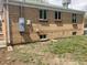 View of home's brick exterior showing multiple windows and access to backyard at 1326 S Canosa Ct, Denver, CO 80219