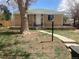 Charming brick home featuring a well-manicured lawn, inviting porch, and mature tree at 1326 S Canosa Ct, Denver, CO 80219