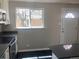 Updated kitchen with black countertops, modern appliances, and a bright window above the sink at 1326 S Canosa Ct, Denver, CO 80219