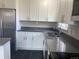 Modern kitchen features stainless steel appliances, sleek gray countertops, and ample cabinet space at 1326 S Canosa Ct, Denver, CO 80219