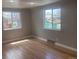 Bright living room featuring hardwood floors and natural light from large windows at 1326 S Canosa Ct, Denver, CO 80219