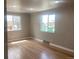 Sunlit living room showcasing hardwood floors and large windows at 1326 S Canosa Ct, Denver, CO 80219