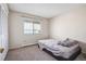 Bedroom featuring neutral carpet, closet, and a window with blinds for natural light at 1112 Elysian Field Dr # E, Lafayette, CO 80026