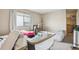 Bright bedroom featuring neutral walls, window with blinds, and carpeted floors at 1112 Elysian Field Dr # E, Lafayette, CO 80026