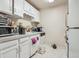 Traditional kitchen with white cabinetry, laminate countertops, and appliances at 1112 Elysian Field Dr # E, Lafayette, CO 80026
