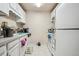 Traditional kitchen features white cabinetry, laminate countertops, and standard appliances at 1112 Elysian Field Dr # E, Lafayette, CO 80026