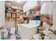 Cluttered laundry room with a washer and dryer, shelves, and various household items at 1112 Elysian Field Dr # E, Lafayette, CO 80026