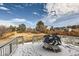 A backyard deck with patio furniture covered with snow at 3416 Hawthorne Dr, Highlands Ranch, CO 80126