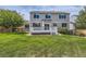 Well-maintained backyard with a spacious deck and lush green lawn at 3416 Hawthorne Dr, Highlands Ranch, CO 80126