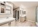 Well-lit primary bathroom with double vanities, tiled floors, and a separate shower and bath area at 3416 Hawthorne Dr, Highlands Ranch, CO 80126